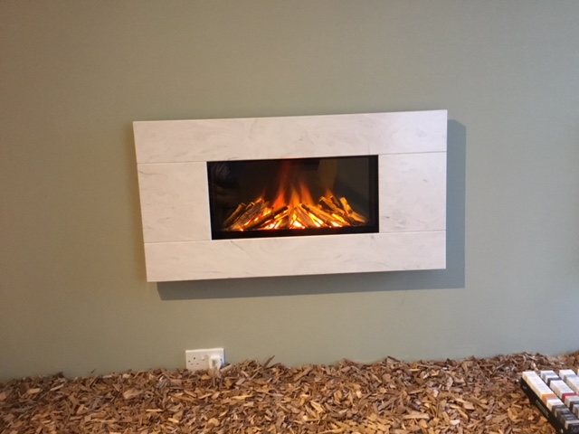Newdawn 1100 electric fire shown in Limestone Prima, flat wall fix, no recess required, simply hang on the wall - On display in our showroom