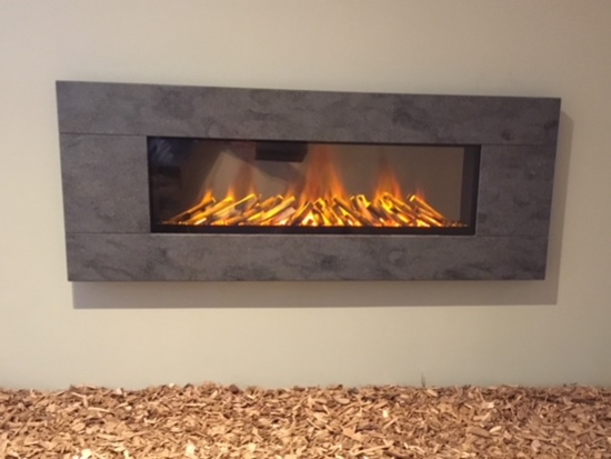 Newdawn 1500 Electric Fire shown in Lavarock, flat wall fix, no recess required, simply hang on the wall - On display in our showroom
